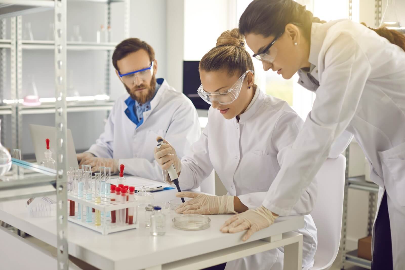 Team of researchers in a university laboratory examining samples together